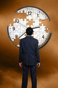 man looking at puzzle clock with missing pieces