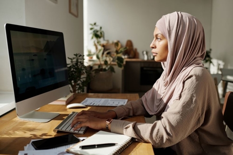 Muslim woman working on computer